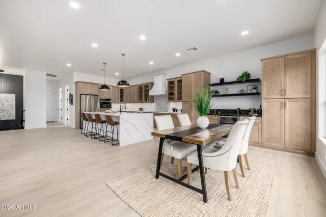 a kitchen with stainless steel appliances kitchen island granite countertop a refrigerator and cabinets