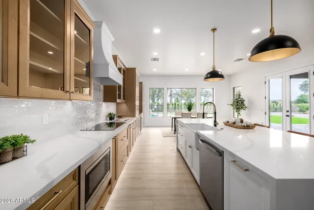 a open kitchen with stainless steel appliances granite countertop a sink a stove and a wooden floors