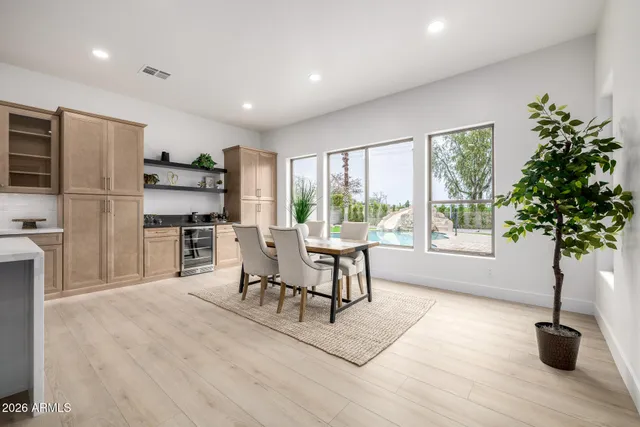 a dining room with furniture and wooden floor