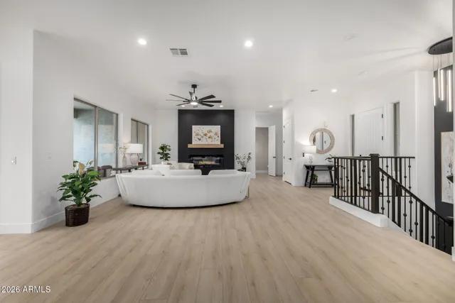 a living room with furniture potted plant and a wooden floor
