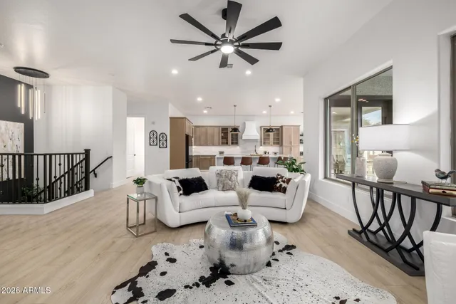 a living room with furniture and a view of kitchen