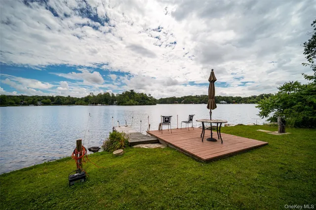 a view of a lake with couches and wooden floor