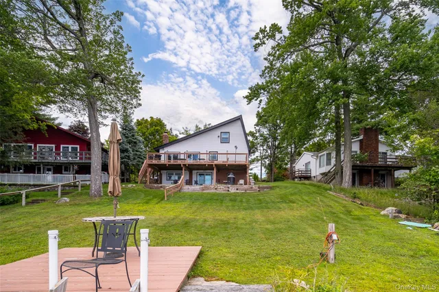 a view of a house with a yard porch and sitting area