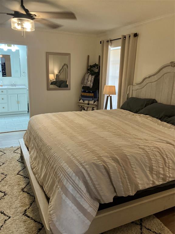 233 Church Road Stonewall, LA 71078 - Photo 15 of 32 Bedroom featuring wood finished floors, a ceiling fan, crown molding, and ensuite bath