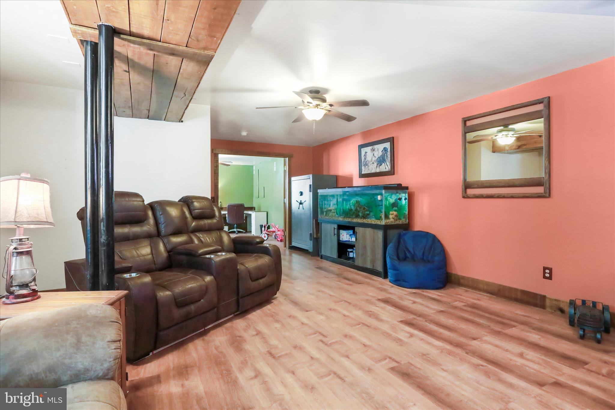 444 Castleton Ford Road Castleton, VA 22716 - Photo 28 of 64 a living room with furniture a fireplace and a window