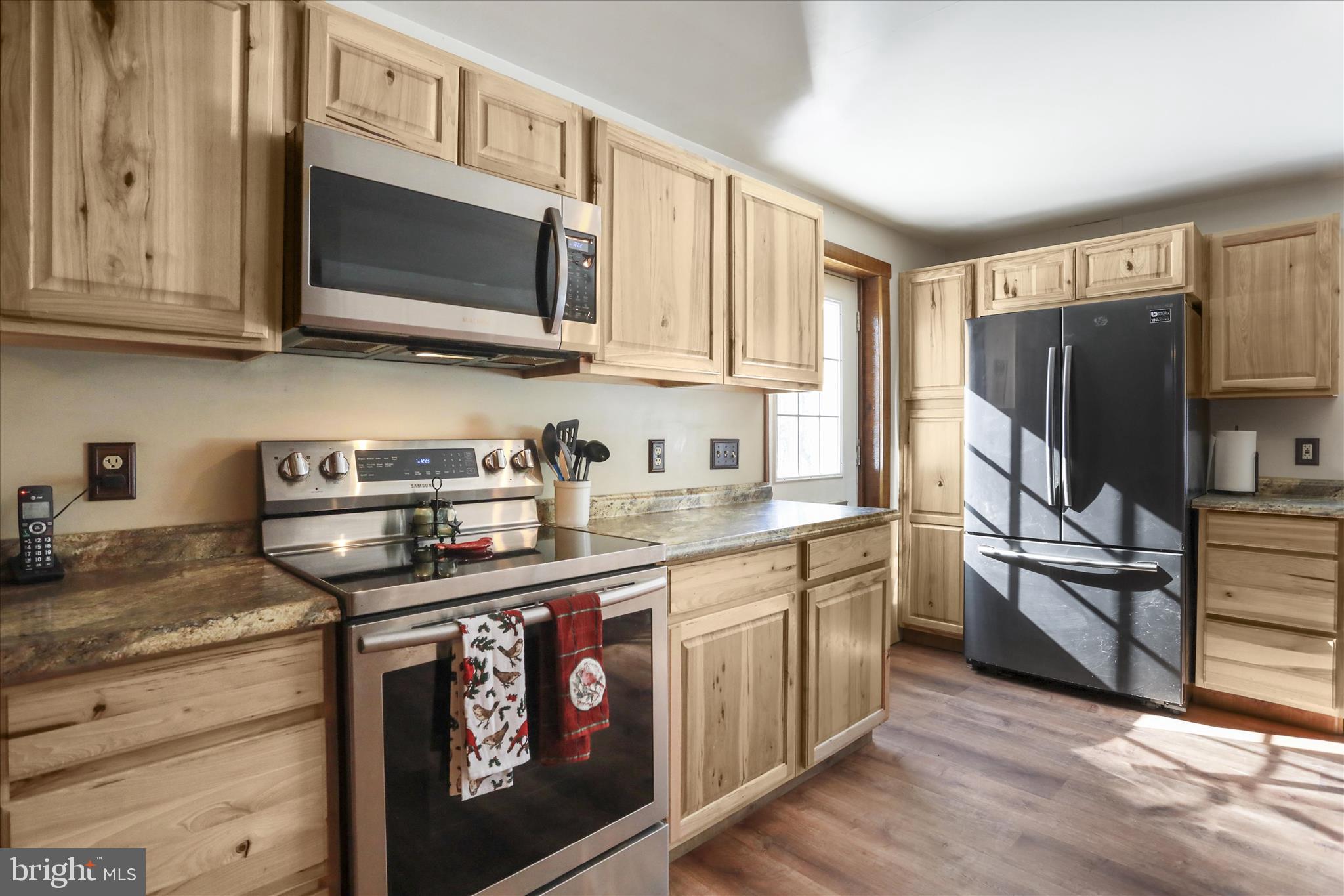 444 Castleton Ford Road Castleton, VA 22716 - Photo 30 of 64 a kitchen with stainless steel appliances granite countertop a stove a sink and a microwave