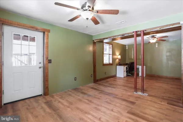 wooden floor in an empty room with a window