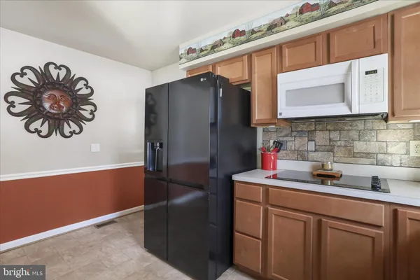 a kitchen with stainless steel appliances granite countertop a sink and a microwave