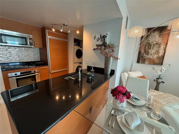 a kitchen with granite countertop a sink stove and refrigerator