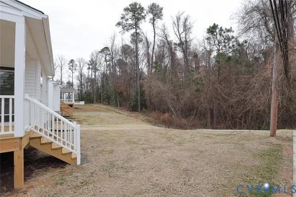 a view of outdoor space with deck and yard
