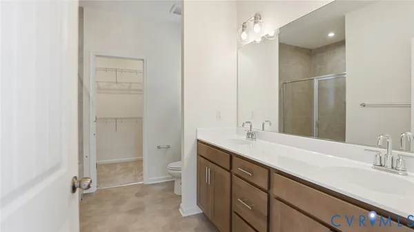 a bathroom with a double vanity sink a mirror and a shower