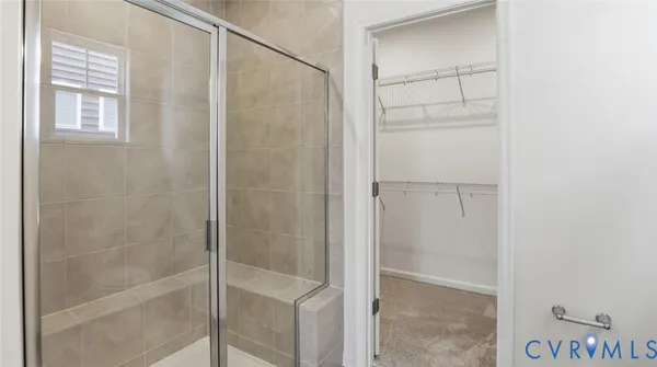 a bathroom with a glass shower door
