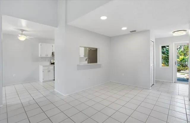 a kitchen with a stove a sink and a window