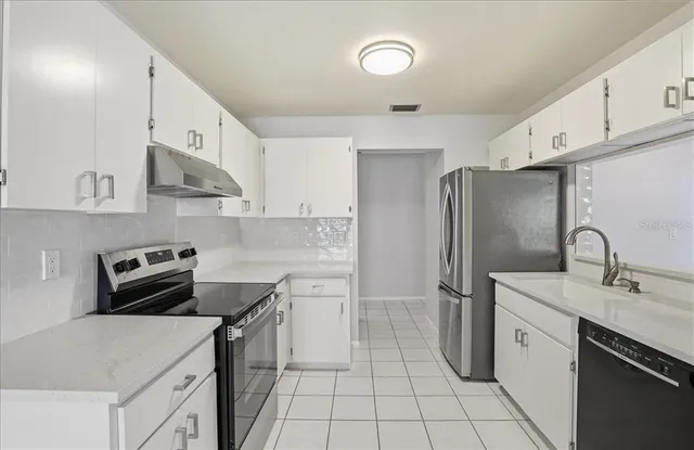 a view of an empty room and wooden floor