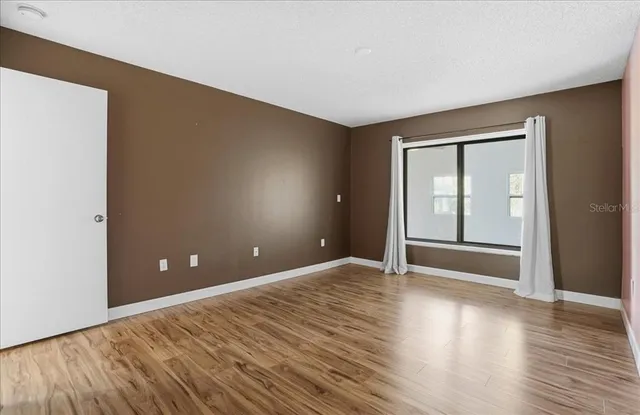 a view of sitting area with furniture and wooden fence