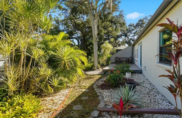 an outdoor space with lots of potted plants