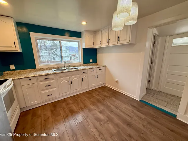 a kitchen with cabinets a sink and appliances