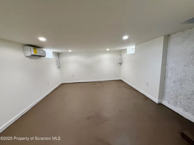 an empty room with a empty space and windows