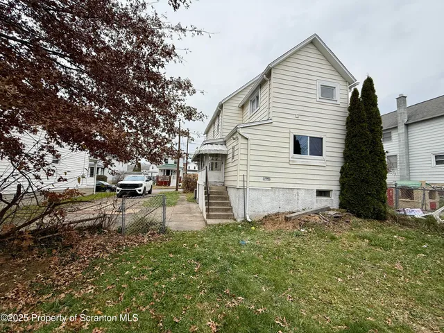 a view of a backyard of the house