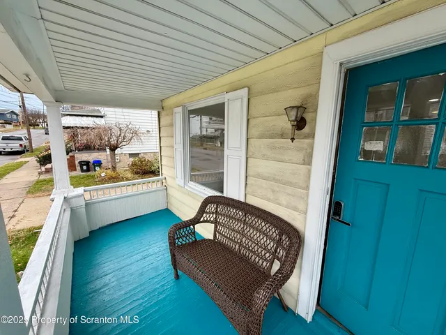 a balcony with furniture and a gate