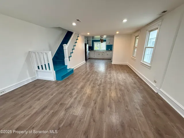 wooden floor with a window in a room