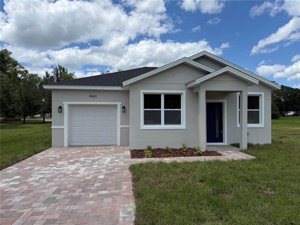 4661 Hickory Tree Road St. Cloud, FL 34772 - Photo 3 of 20 a front view of a house with a garden