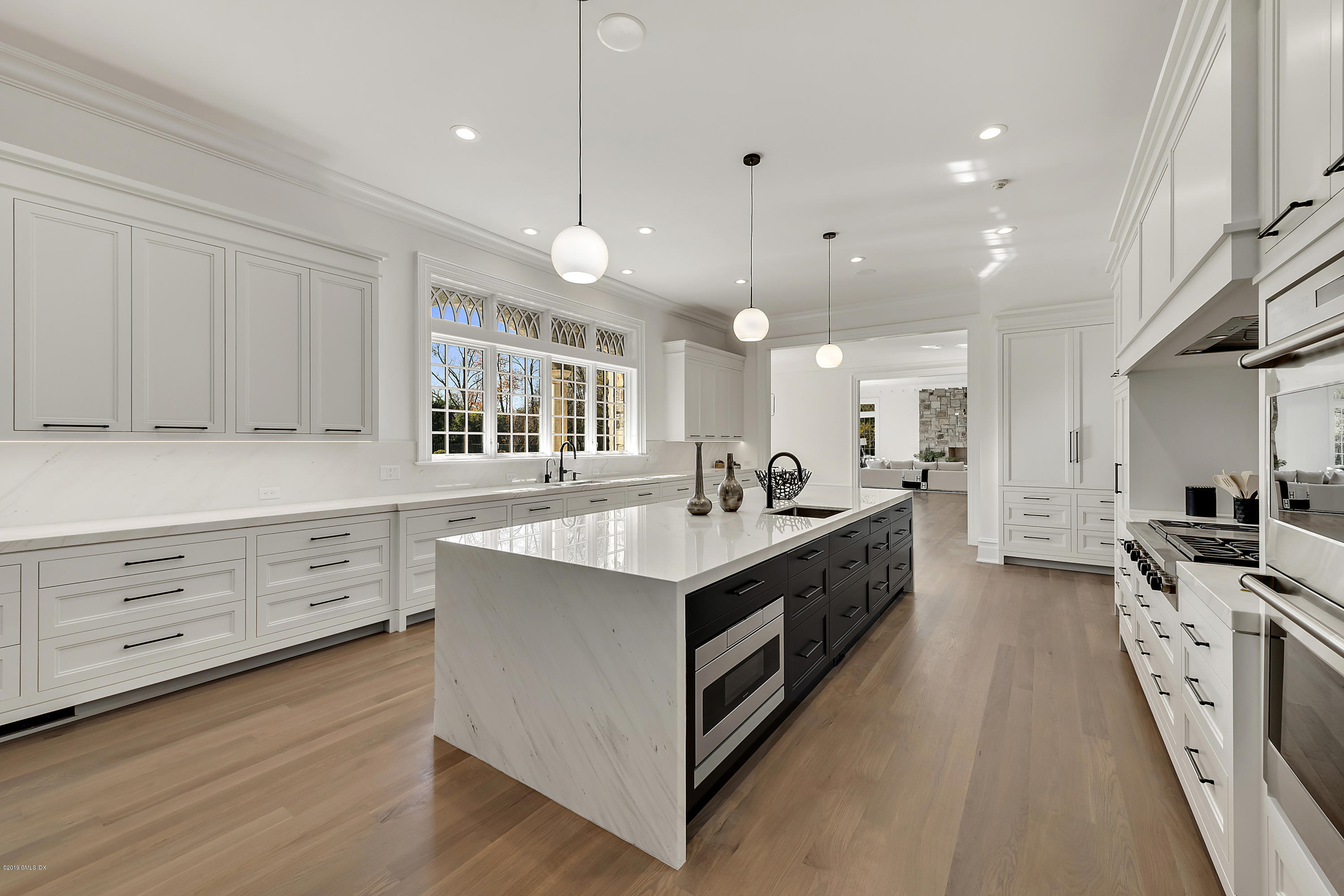 7 Loch Lane Greenwich, CT 06830 - Photo 12 of 41 a large kitchen with stainless steel appliances lots of counter space and wooden floor