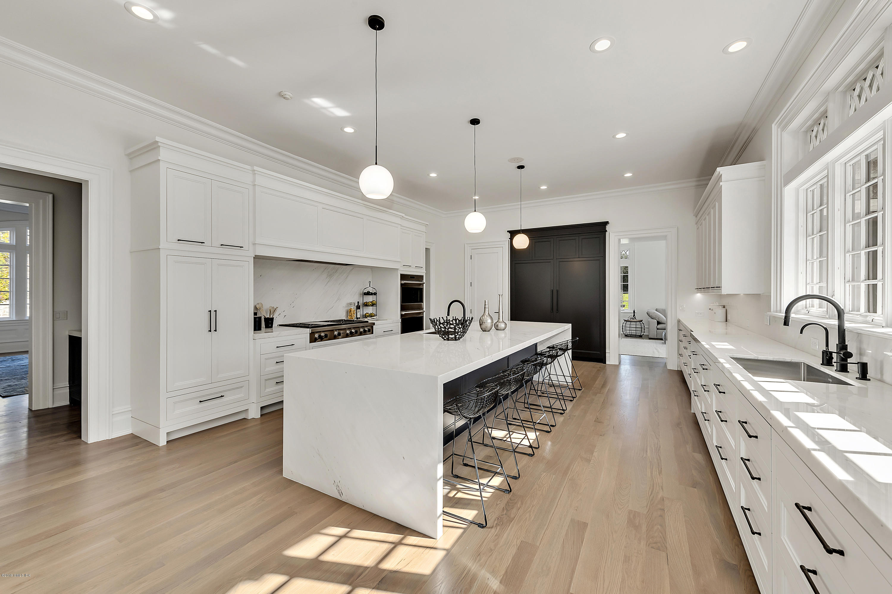 7 Loch Lane Greenwich, CT 06830 - Photo 13 of 41 a large white kitchen with wooden floor and a sink