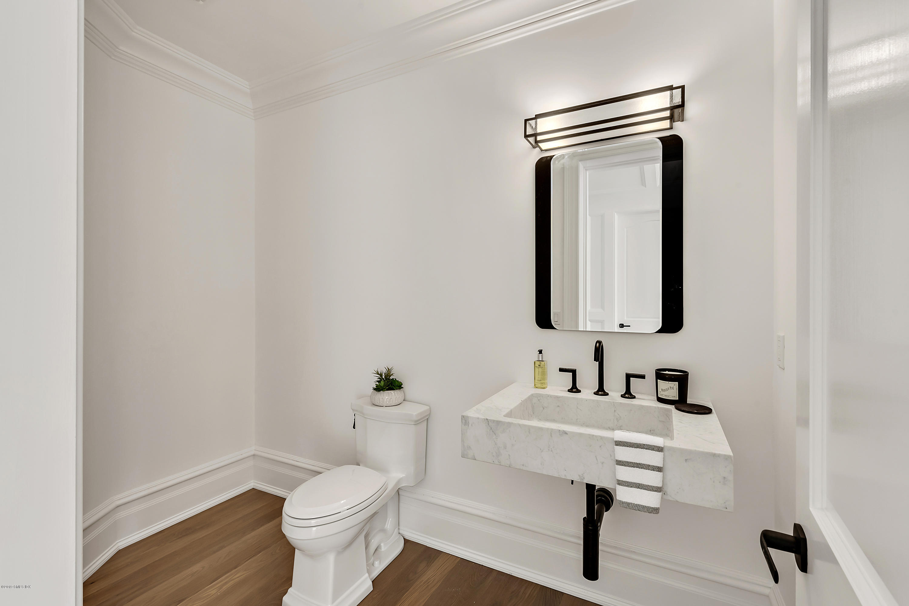 7 Loch Lane Greenwich, CT 06830 - Photo 23 of 41 a bathroom with a toilet sink and mirror