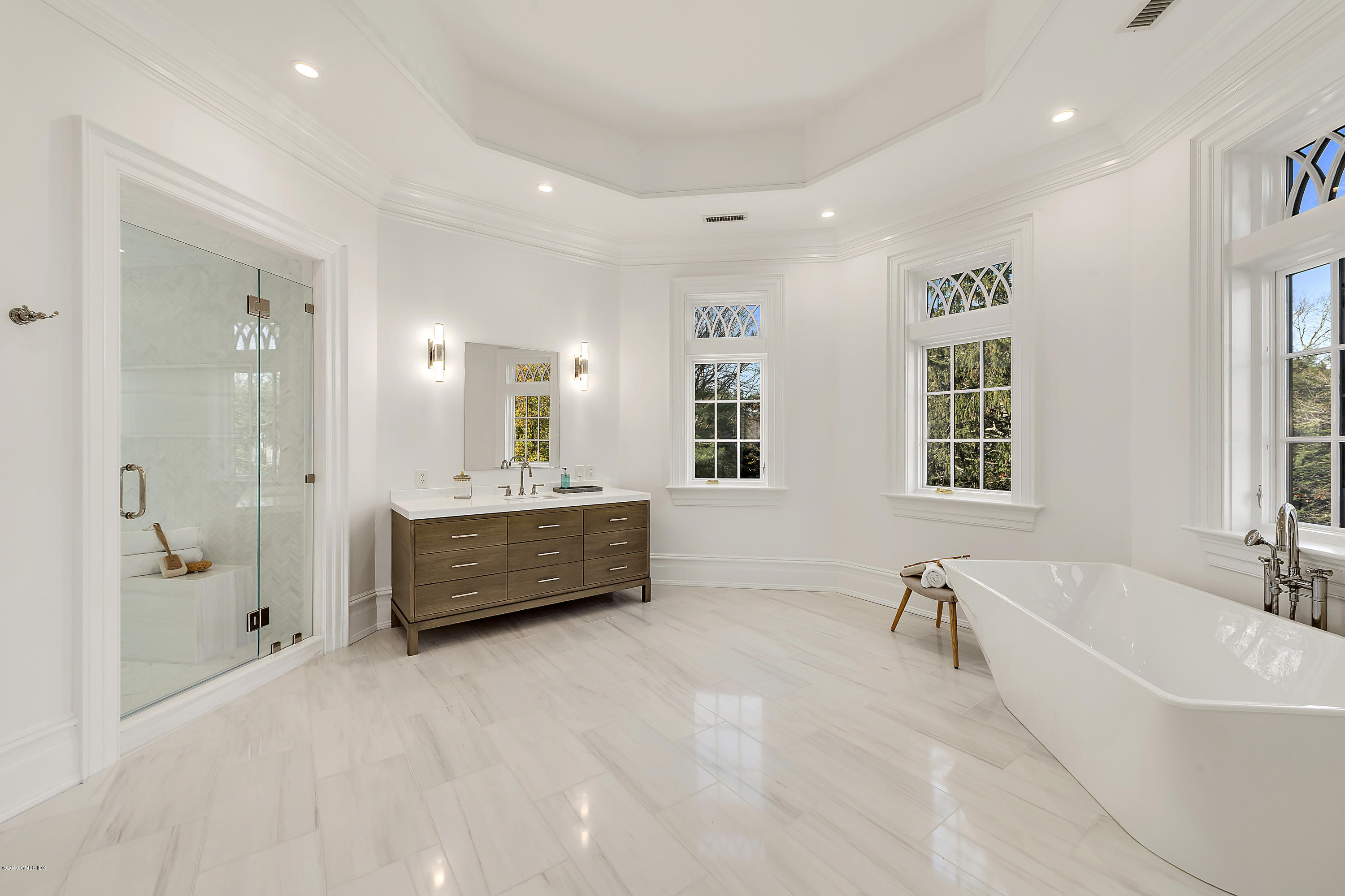 7 Loch Lane Greenwich, CT 06830 - Photo 28 of 41 a bathroom with a tub a double vanity sink a window and a mirror