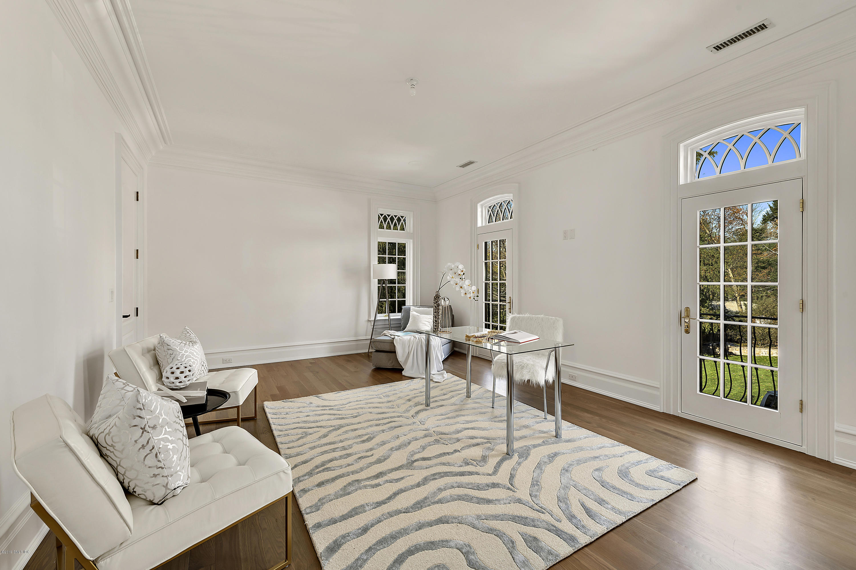 7 Loch Lane Greenwich, CT 06830 - Photo 30 of 41 a bedroom with a bed and wooden floor