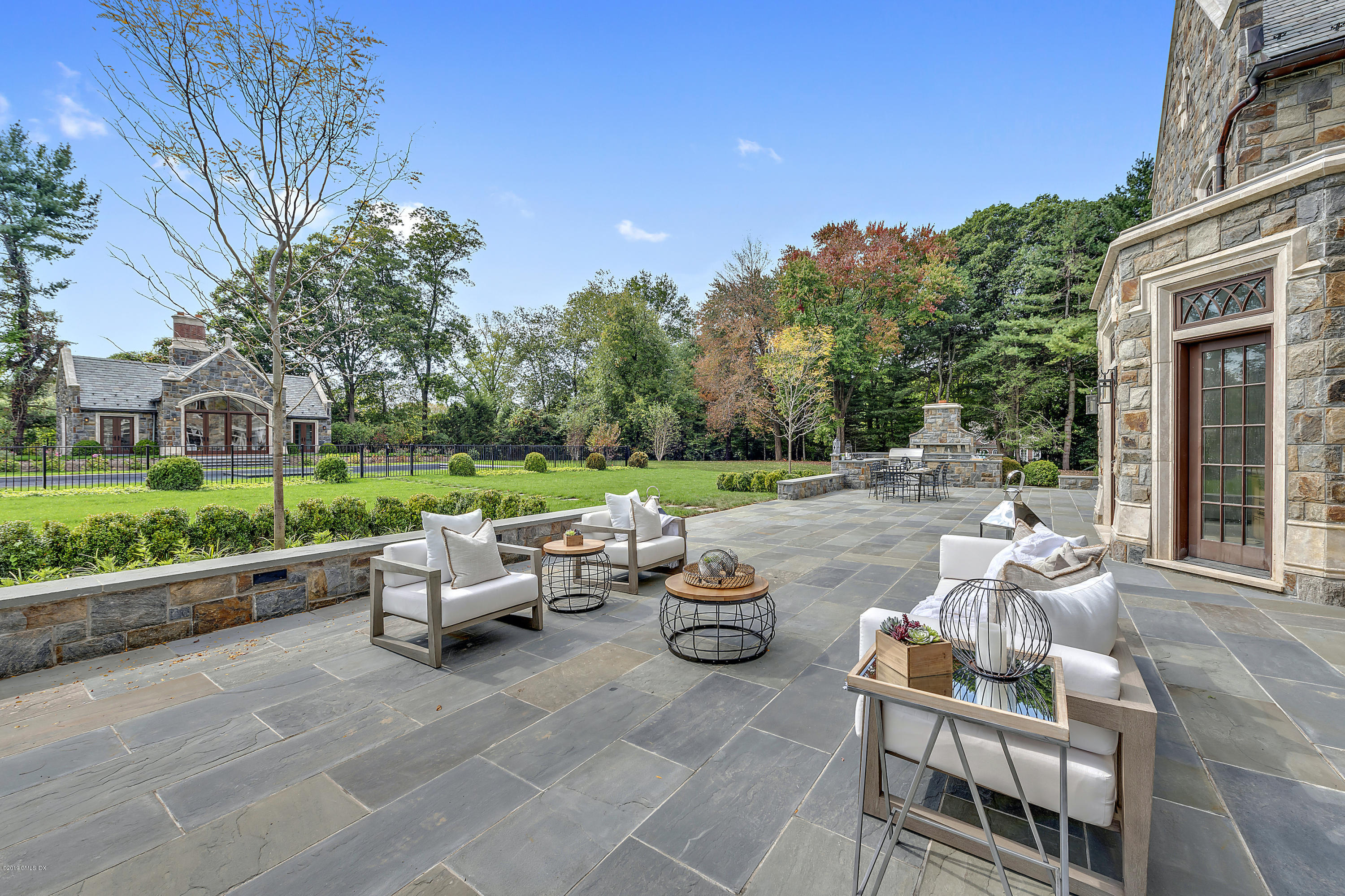 7 Loch Lane Greenwich, CT 06830 - Photo 3 of 41 a backyard of a house with table and chairs