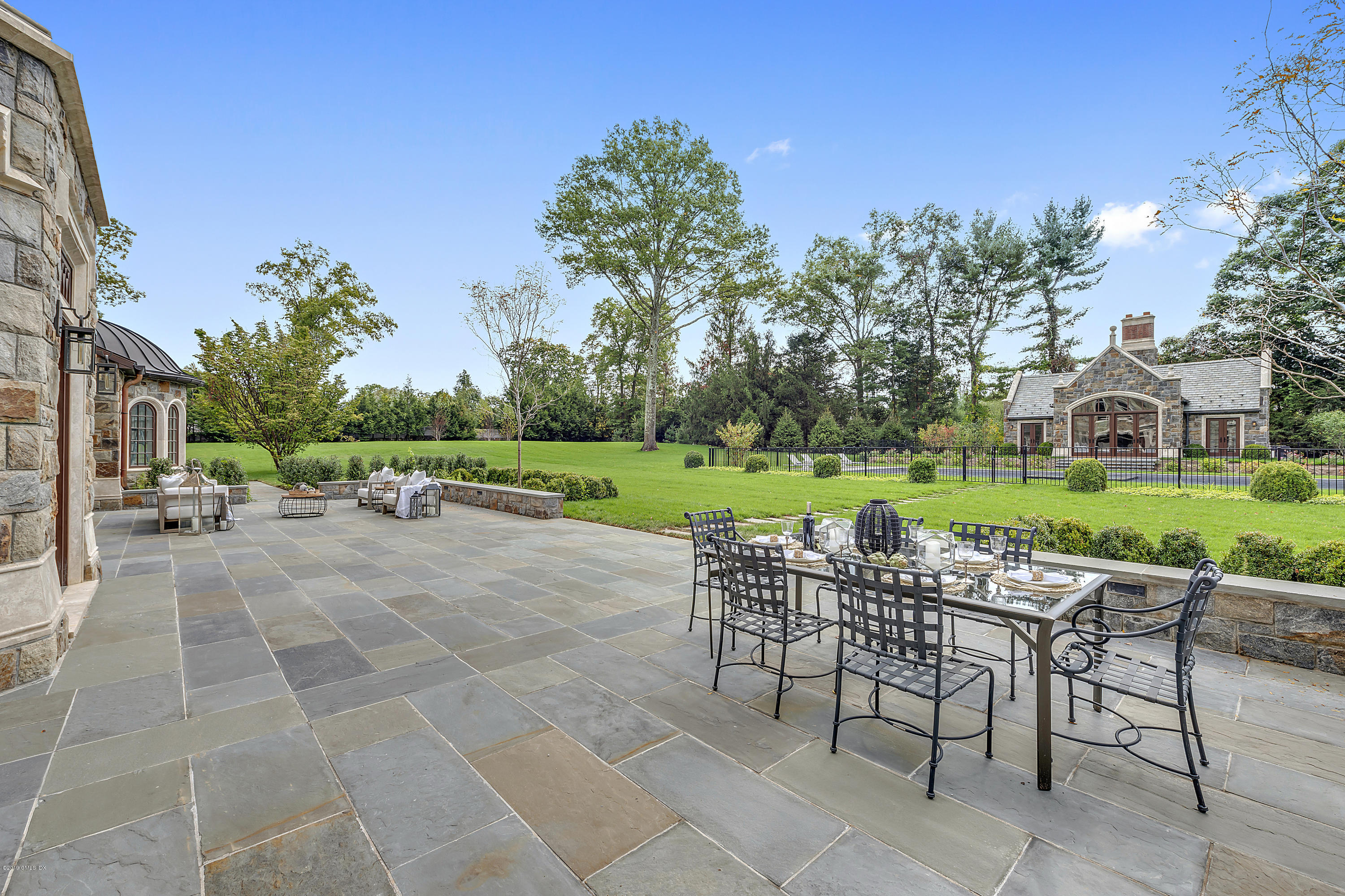 7 Loch Lane Greenwich, CT 06830 - Photo 4 of 41 a view of a chairs and table in the back yard of the house