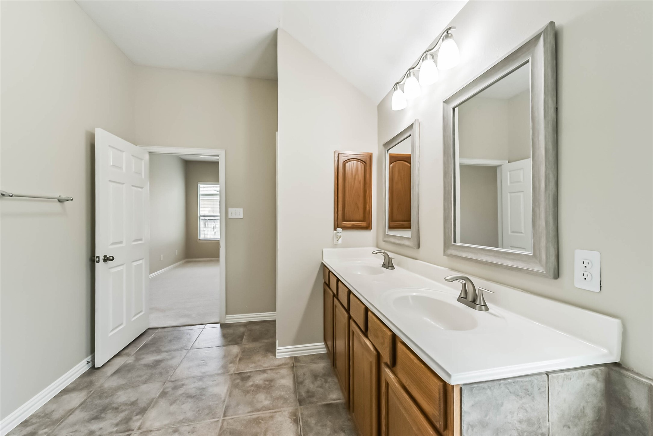 30910 Blue Ridge Park Lane Spring, TX 77386 - Photo 29 of 50 Spacious bathroom featuring a double vanity with elegant mirrors and ample cabinetry, enhanced by sleek tile flooring and soft lighting.