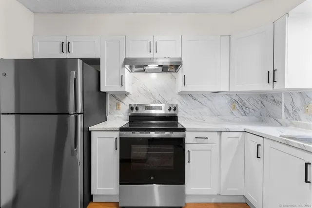 a kitchen with a stove and a refrigerator