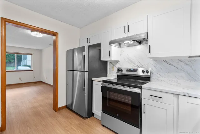 a kitchen with cabinets and stainless steel appliances