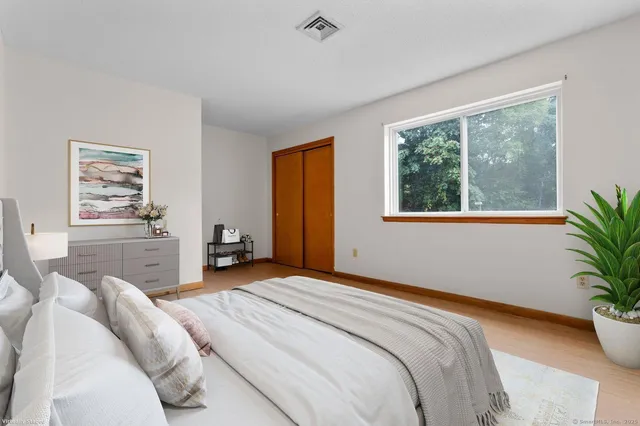 a bedroom with a bed and a potted plant