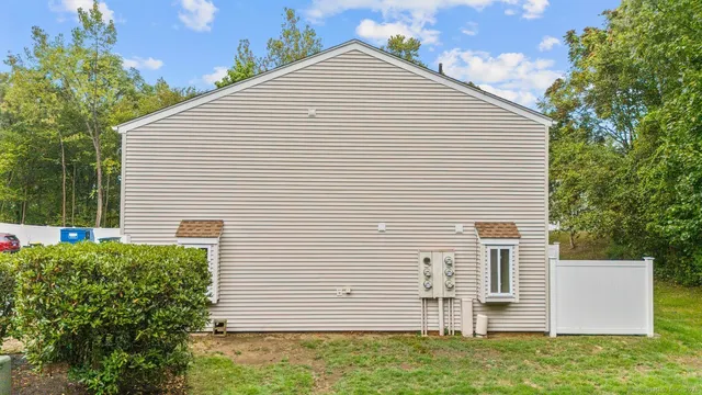 a view of a white house with a yard and plants