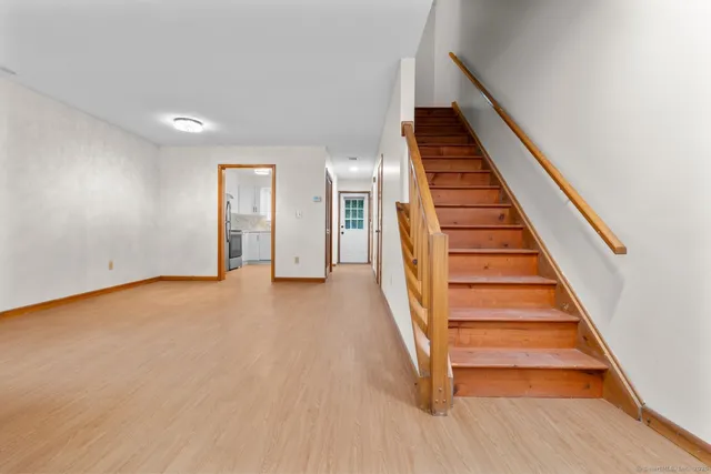 a view of entryway and hall with wooden floor
