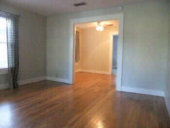 2518 23rd Street Lubbock, TX 79410 - Photo 4 of 9 an empty room with wooden floor and windows