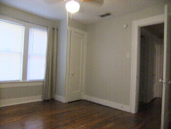 2518 23rd Street Lubbock, TX 79410 - Photo 7 of 9 an empty room with wooden floor and windows
