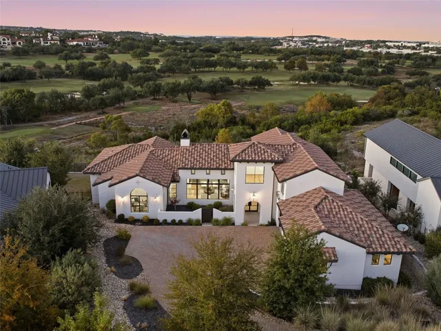 an aerial view of house with yard and mountain view in back