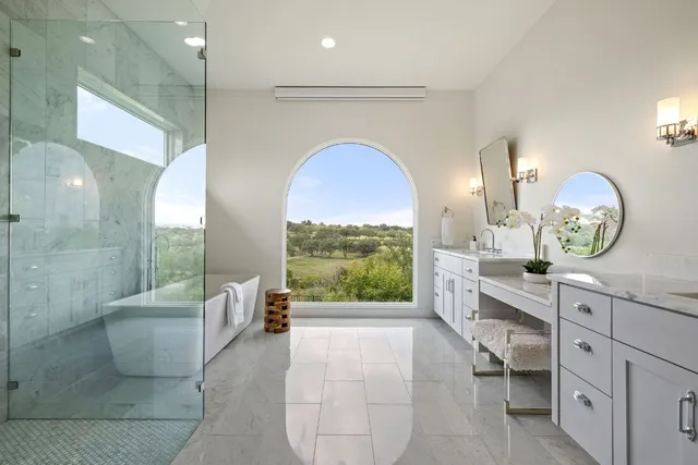 a bedroom with a bed a couch and a potted plant