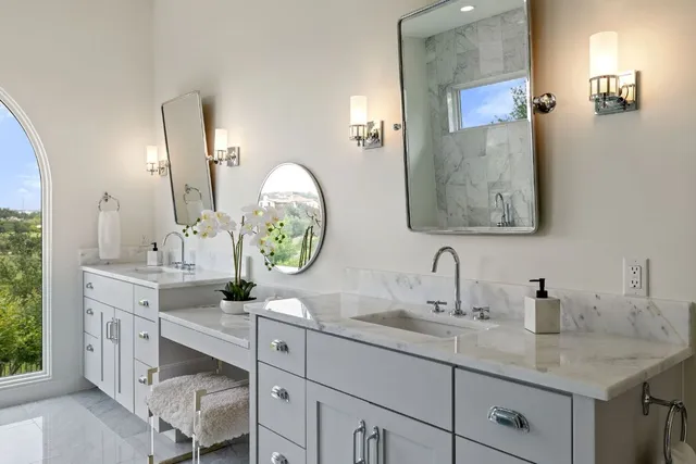 a large spacious bathroom with a large tub sink and shower