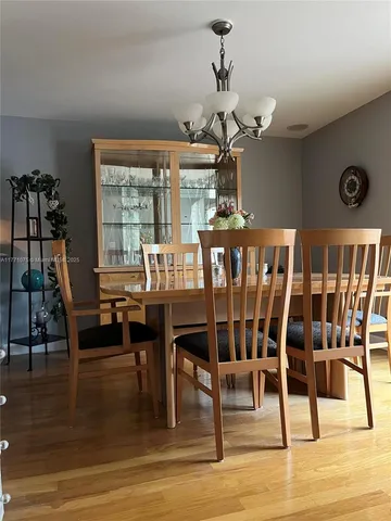 a view of a dining room with furniture wooden floor and chandelier