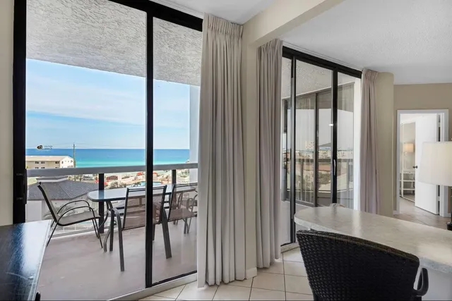 a balcony with a bench and a floor to ceiling window