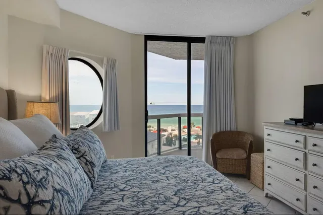 a large bed sitting in a bedroom next to a lamp