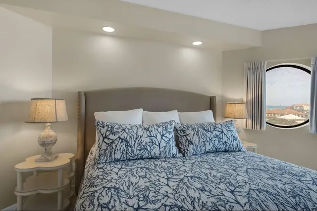 a bedroom with a large bed and a large window