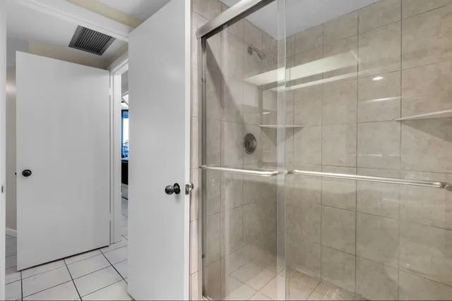 a bathroom with a granite countertop sink a large mirror and a toilet