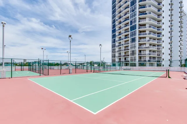 a view of a building with car parked